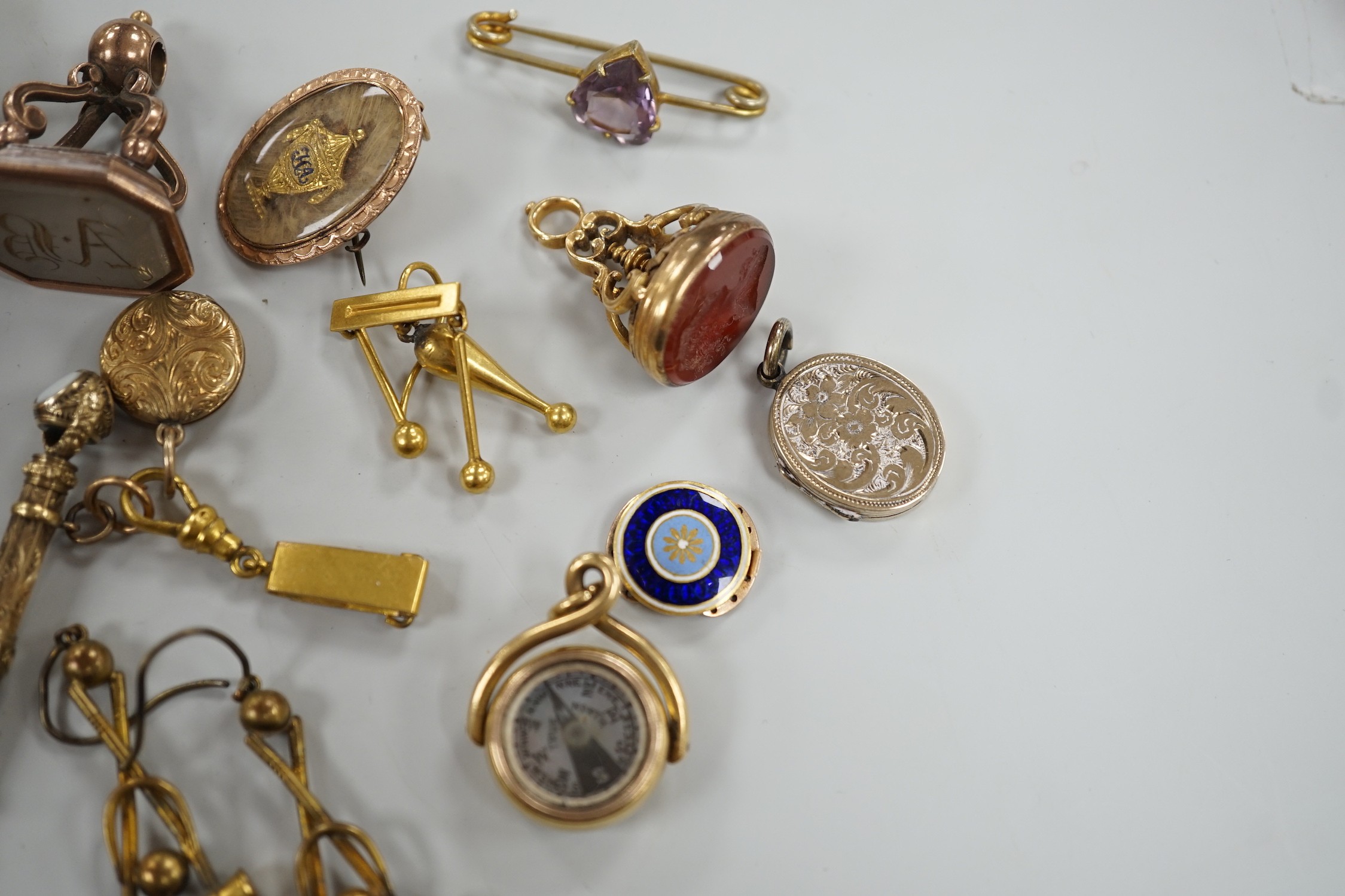 Mixed collectables including a yellow metal clam shell mourning pendant, 22mm, a George III yellow metal and plaited hair mourning brooch, with central urn and engraved inscription verso, three assorted 19th century and